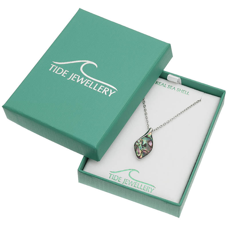 A silver chain necklace with an iridescent abalone shell pendant displayed in an open teal Tide Jewellery gift box on a white background.