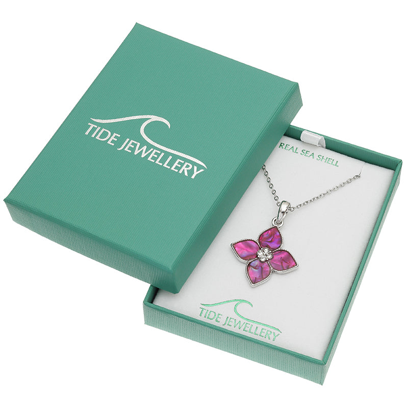 A silver-tone flower pendant necklace with pink shell inlays, presented in an open mint green Tide Jewellery gift box on a white background.
